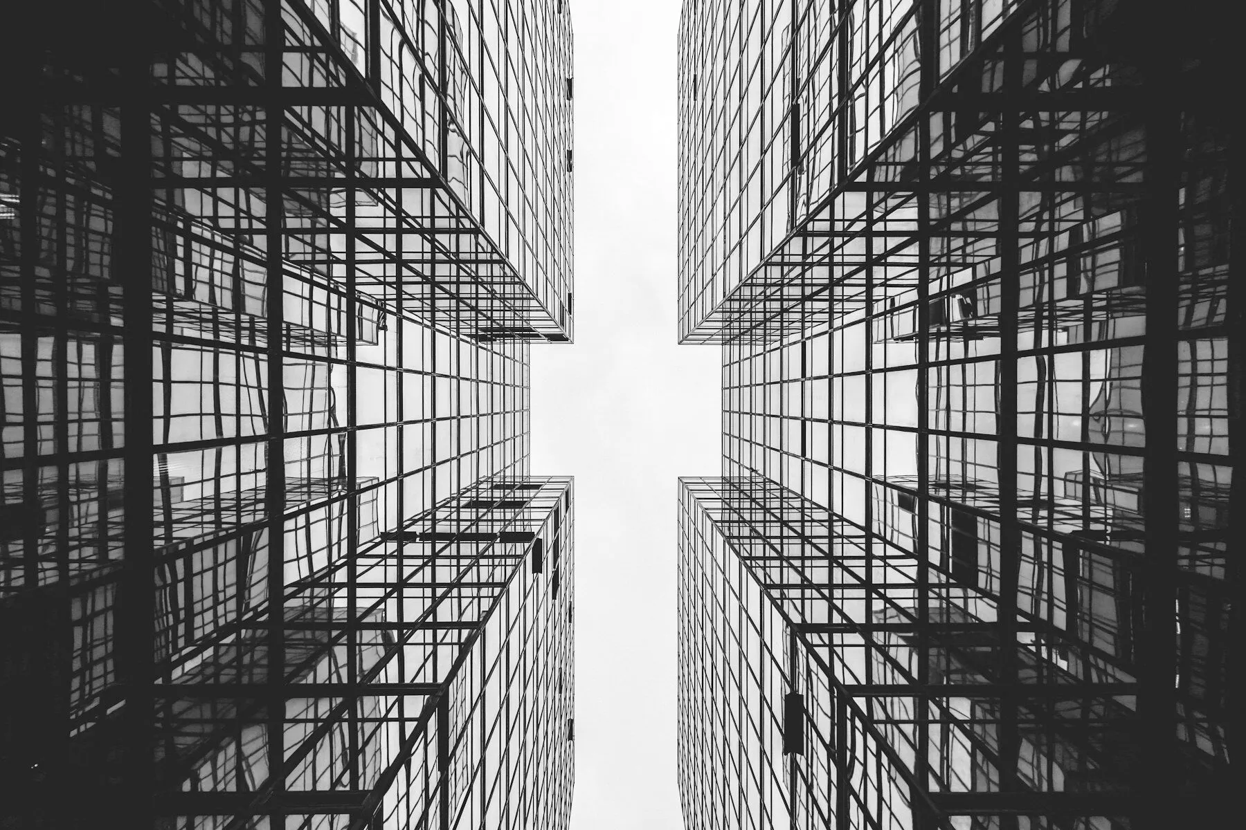 Reflective office towers converging overhead