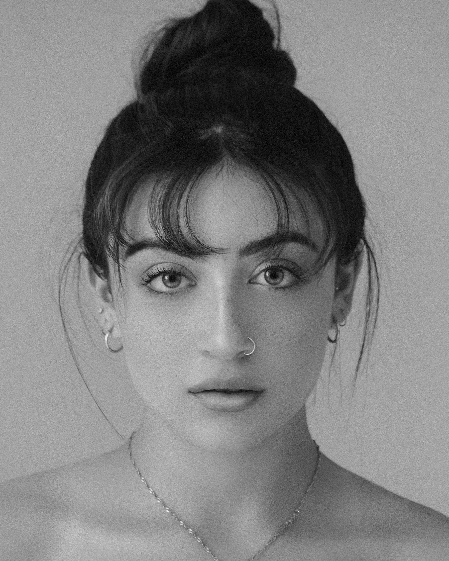 Close portrait of a young woman with her hair tied up