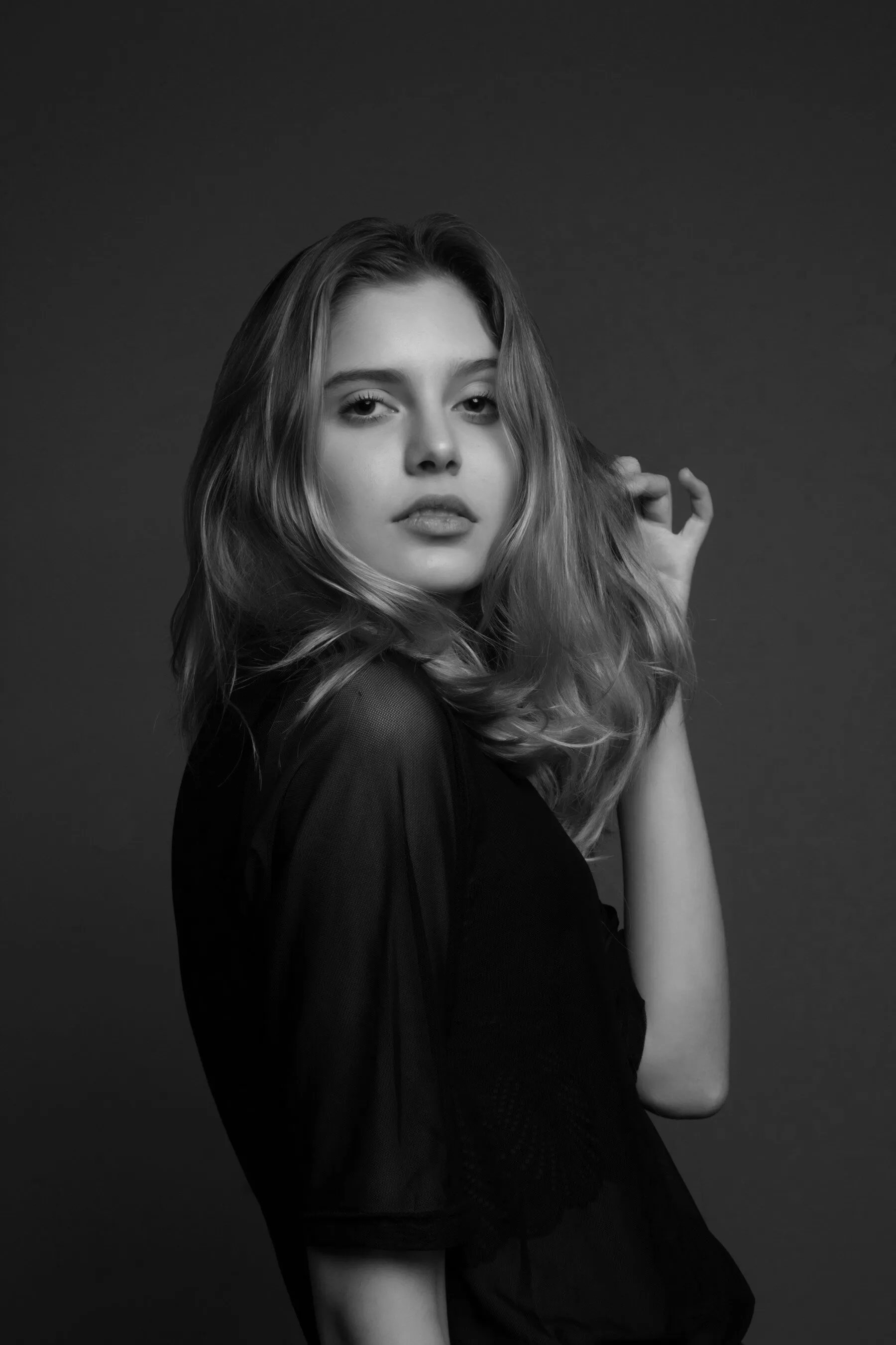 Portrait of a woman against a dark ground